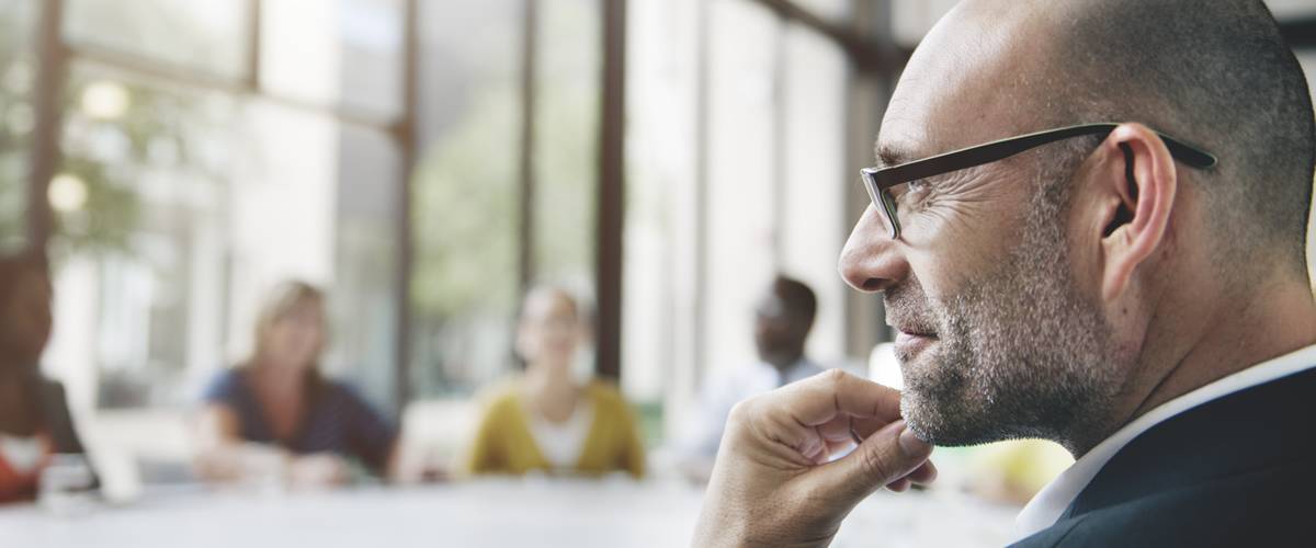 man listening in meeting